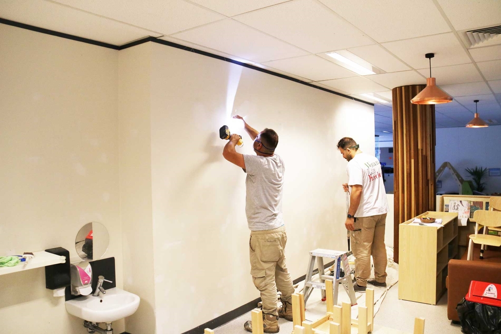 Painters preparing walls at Guardian Childcare Bruce for interior painting