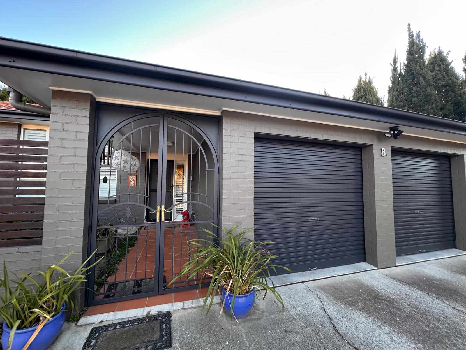 Freshly painted black garage doors in Isaacs