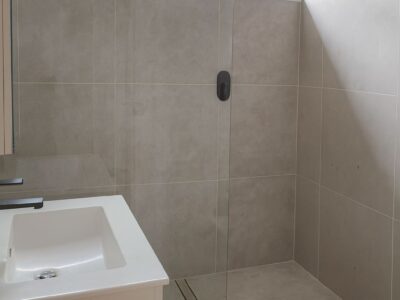 finished bathroom with frameless glass shower and full wall tiling in red hill canberra