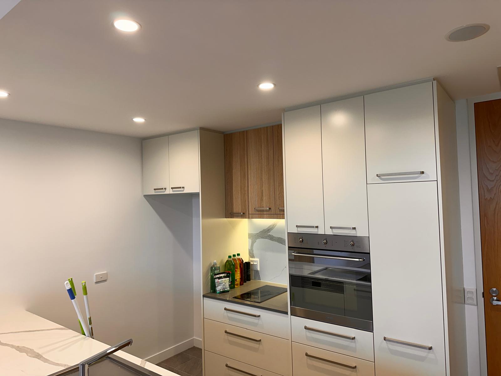 modern kitchen with new ceiling lights and wood-white cabinetry in Manuka, Canberra.
